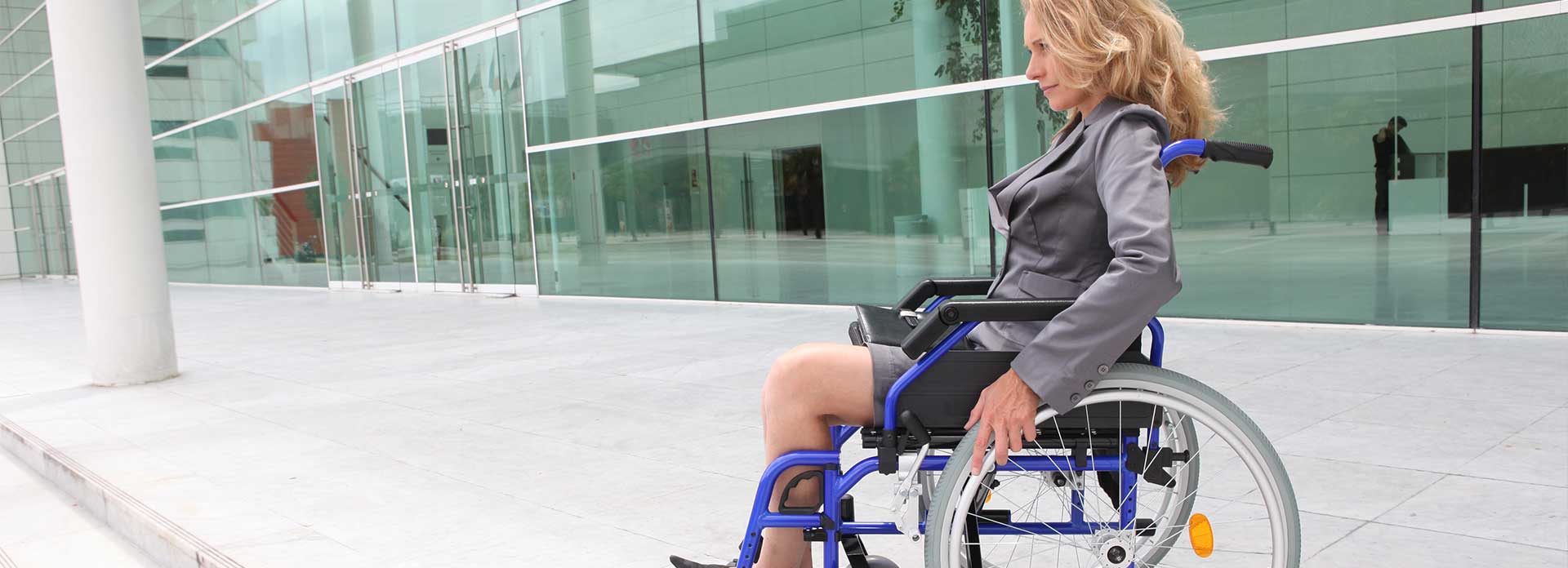 Woman in a wheelchair outside an office building